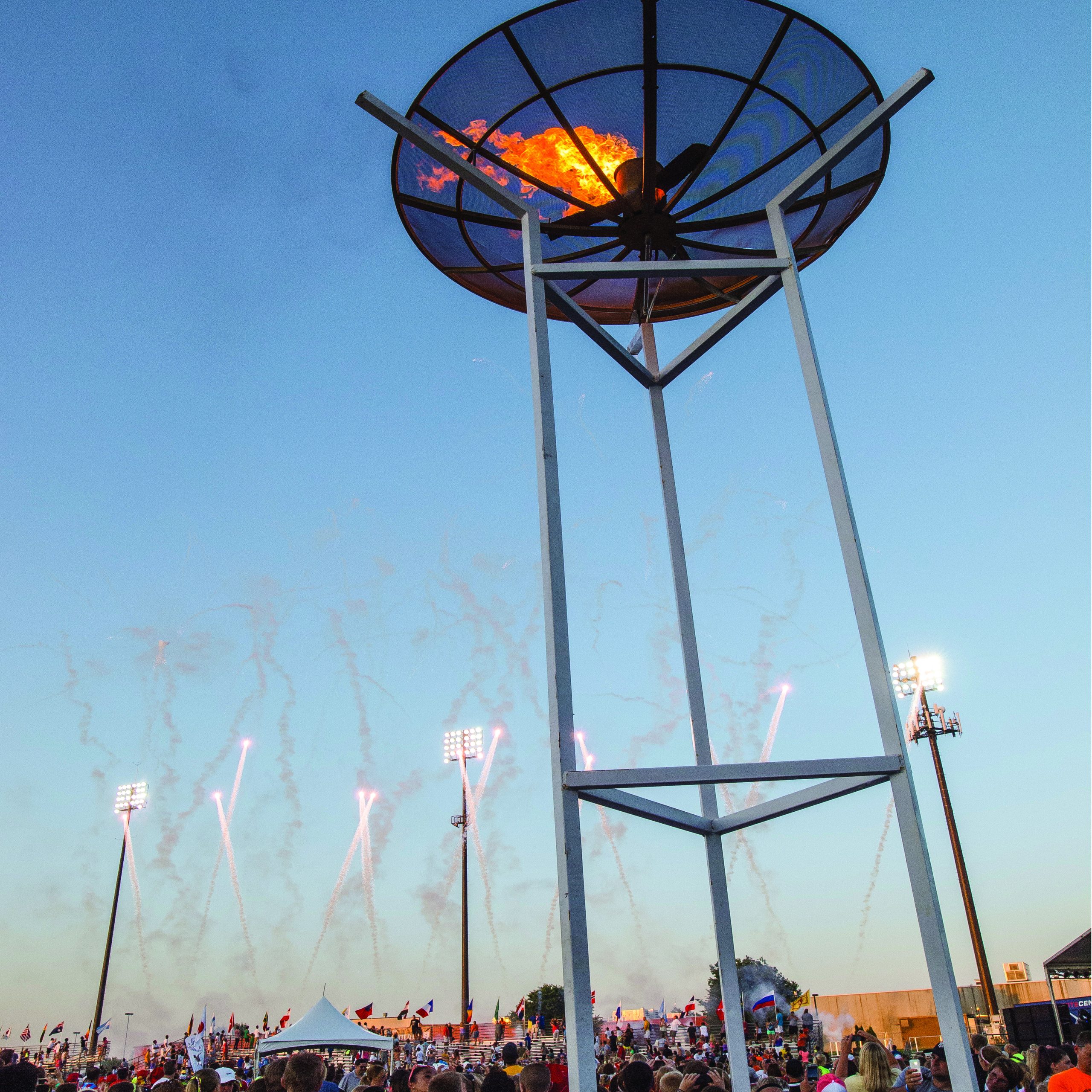 Lighting of USA CUP Torch at Opening Ceremonies as fireworks light up the sky.